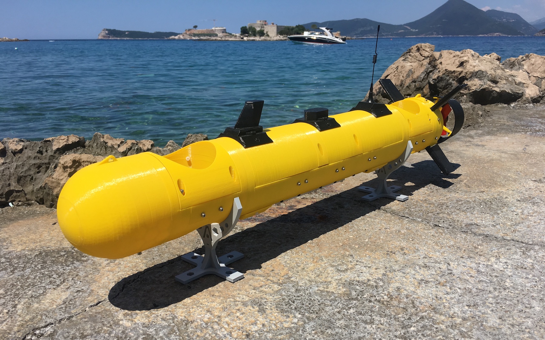 Yellow E/Xplorer AUV on stands by the shore